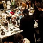 Shoppers browsing collectibles at an antique market stall